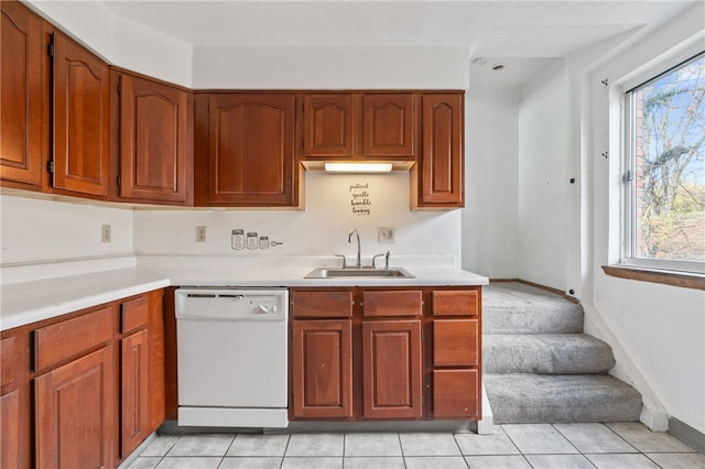 kitchen with sink, light tile patterned floors, and white dishwasher