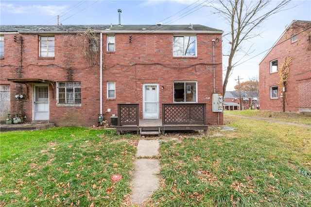 back of house with a lawn