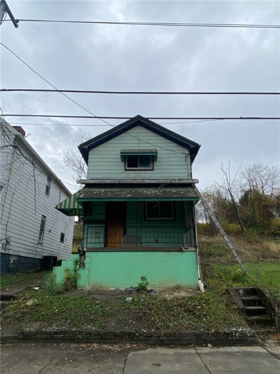 bungalow featuring central AC and covered porch