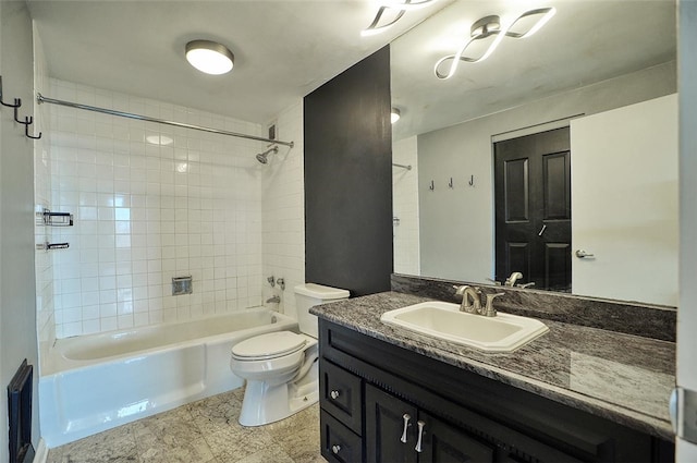 full bathroom with vanity, tiled shower / bath, and toilet