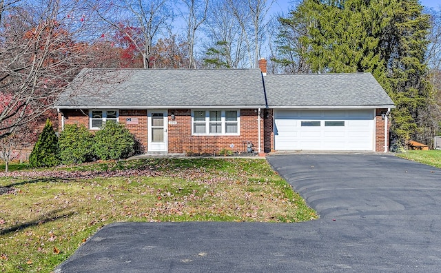 single story home with a garage and a front yard