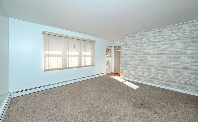 empty room with a baseboard heating unit, carpet flooring, and plenty of natural light