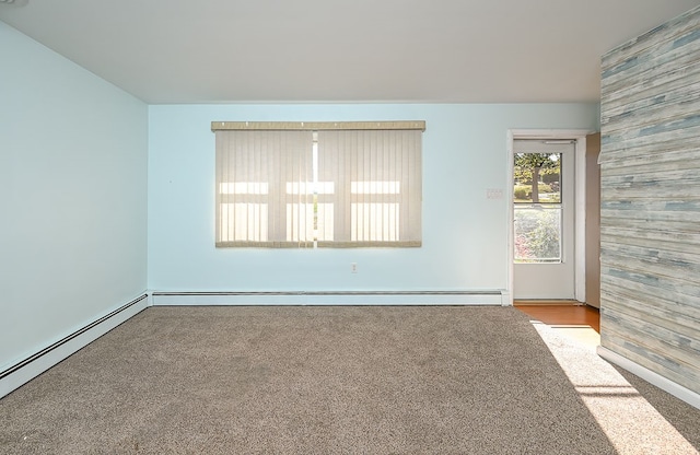 empty room with baseboard heating and light colored carpet