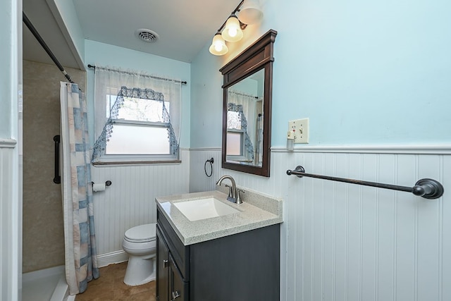 bathroom with toilet, vanity, tile patterned floors, and curtained shower