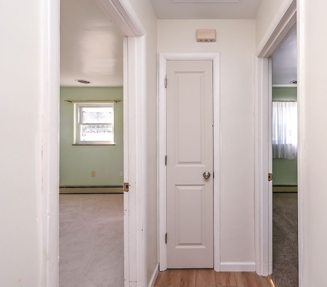 hall featuring light hardwood / wood-style floors and a baseboard radiator