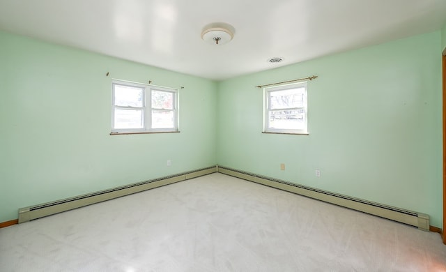 empty room featuring light colored carpet and a healthy amount of sunlight