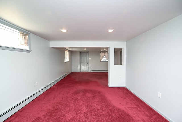 basement with carpet and a baseboard heating unit