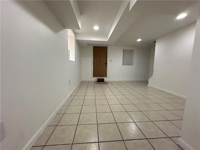 basement featuring light tile patterned floors