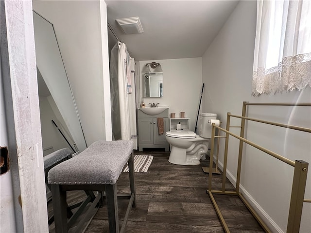 bathroom with hardwood / wood-style flooring, vanity, and toilet