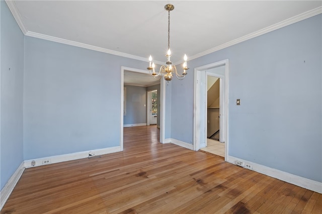 unfurnished dining area featuring ornamental molding, an inviting chandelier, and light hardwood / wood-style floors