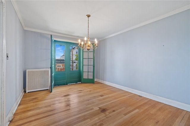 unfurnished dining area featuring french doors, radiator heating unit, light hardwood / wood-style floors, and crown molding