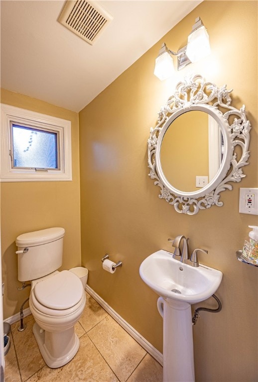 bathroom featuring tile patterned flooring and toilet