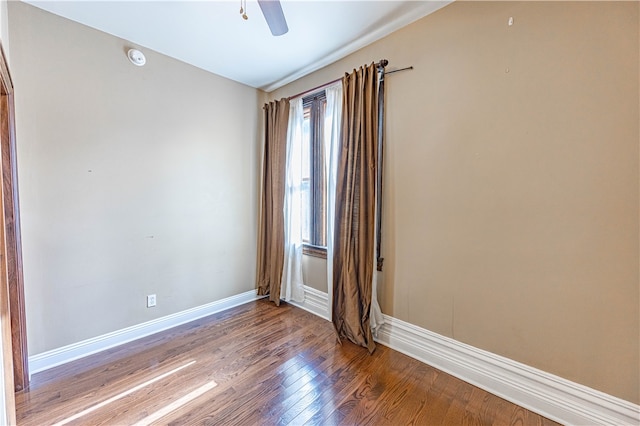 unfurnished room with hardwood / wood-style flooring and ceiling fan