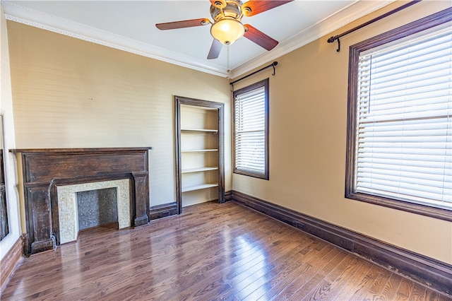 unfurnished living room featuring dark wood-type flooring, ceiling fan, and crown molding