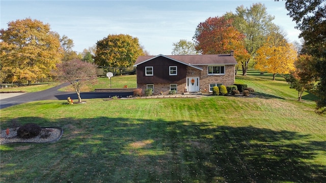 rear view of house featuring a lawn