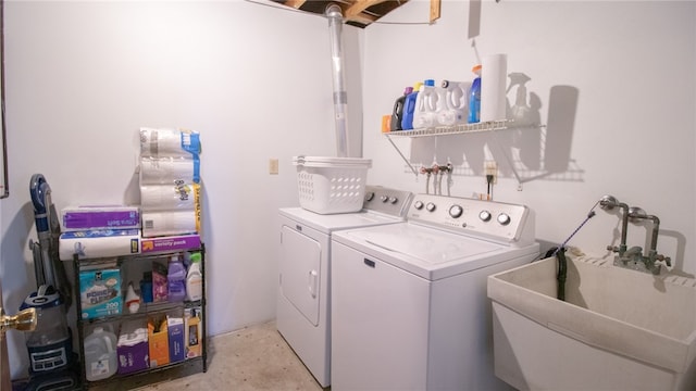 washroom with washing machine and clothes dryer and sink