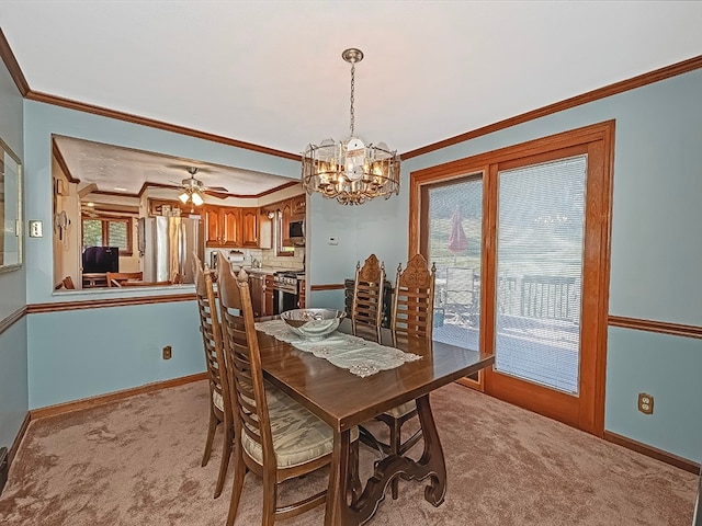 carpeted dining room featuring ceiling fan with notable chandelier and ornamental molding