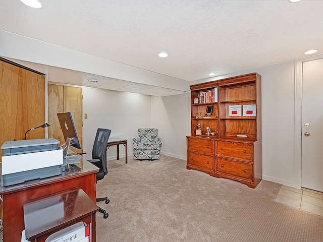 office area featuring a textured ceiling and light carpet