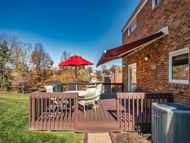 wooden terrace featuring central AC and a yard