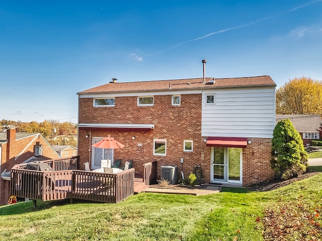 back of house with central air condition unit, a yard, and a wooden deck