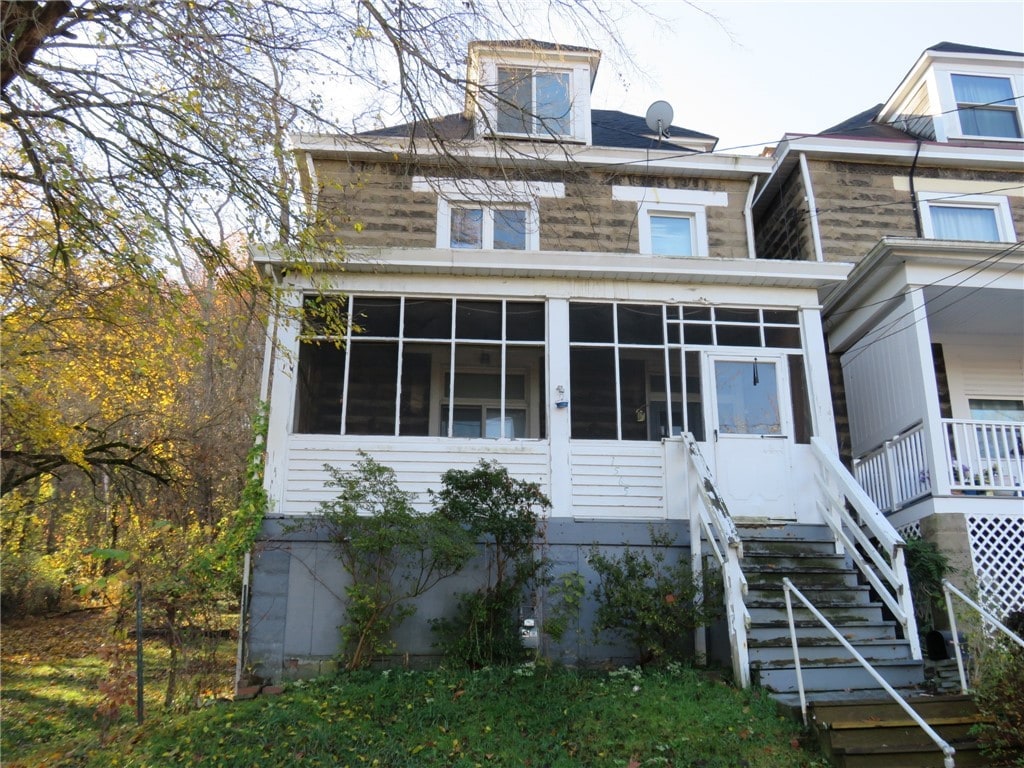 view of front of home featuring a sunroom