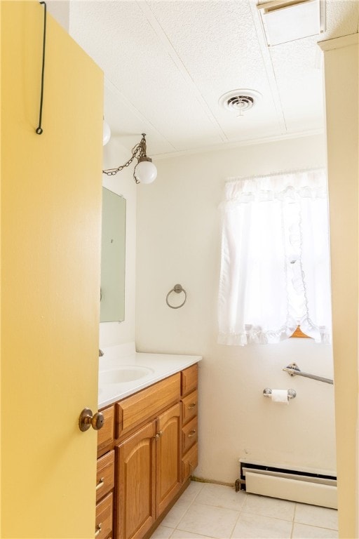 bathroom featuring tile patterned flooring, a baseboard radiator, vanity, and a textured ceiling