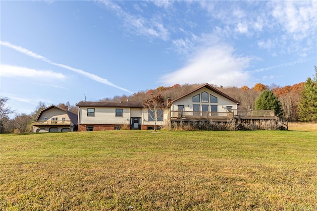 rear view of property featuring a deck and a lawn