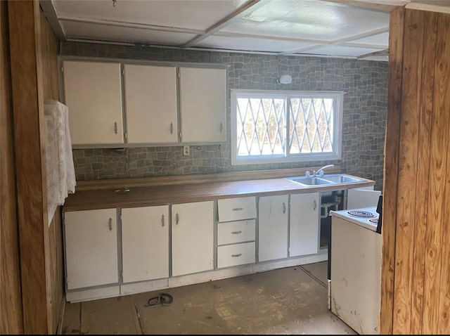 kitchen featuring white cabinetry, white range with electric cooktop, sink, and tasteful backsplash