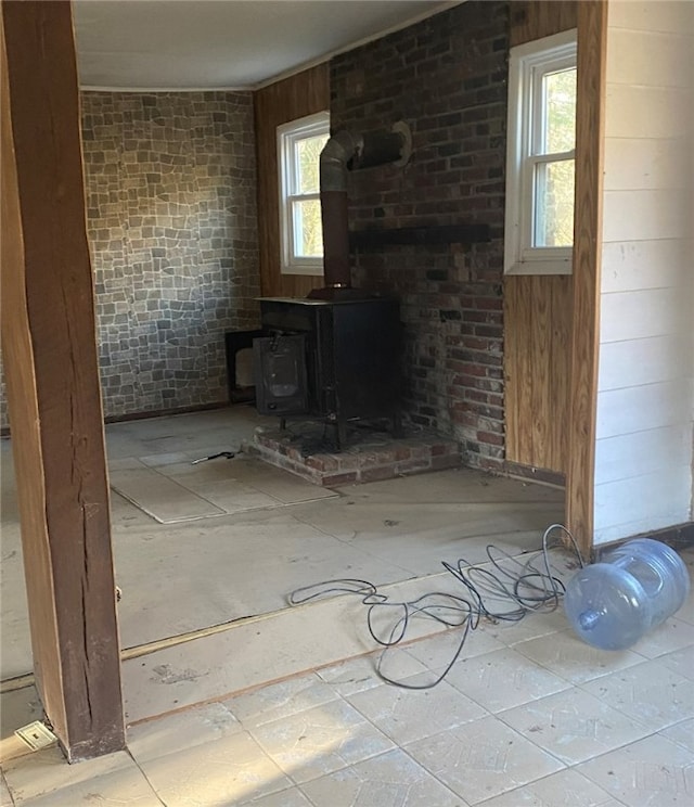 unfurnished living room with a wood stove