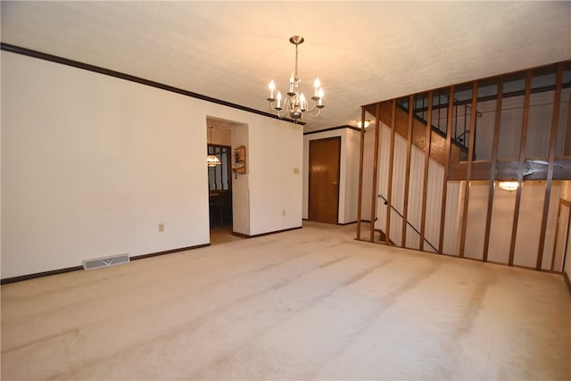 empty room with carpet, a chandelier, and crown molding