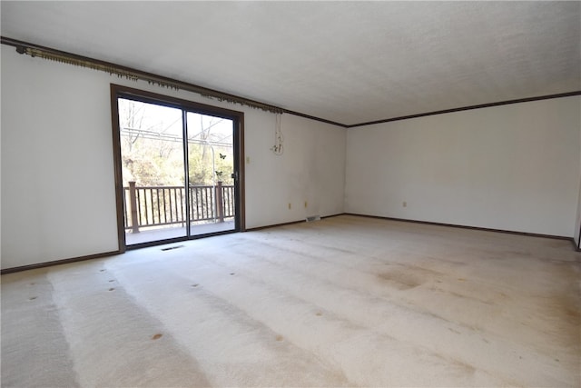 carpeted empty room with a textured ceiling and ornamental molding