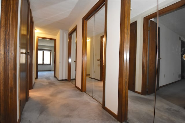 hallway with light colored carpet