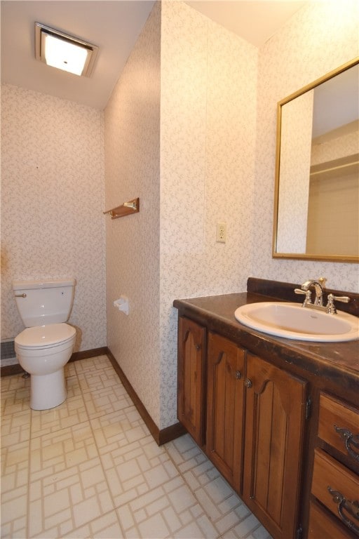 bathroom with toilet and vanity