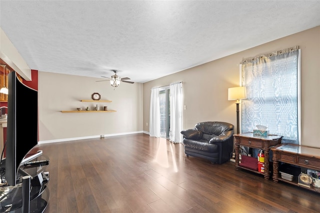 living room featuring a textured ceiling and dark hardwood / wood-style floors