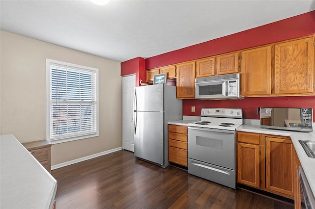 kitchen featuring stainless steel appliances and dark hardwood / wood-style flooring