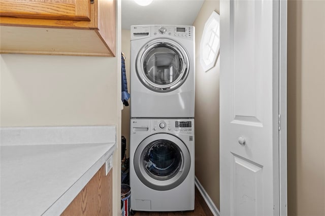 laundry room with stacked washer and dryer