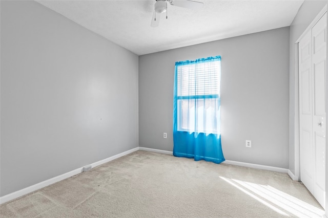 carpeted empty room with ceiling fan