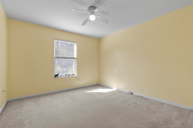 unfurnished room featuring light carpet and ceiling fan