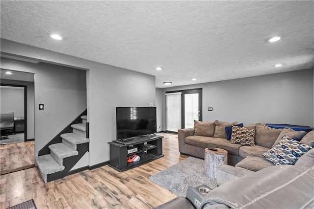 living room with hardwood / wood-style floors and a textured ceiling