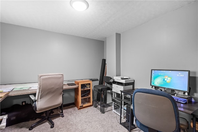 carpeted office space featuring a textured ceiling