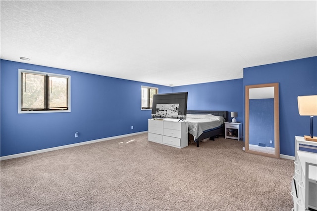 bedroom with multiple windows and carpet flooring