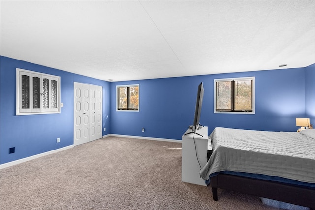 bedroom with a textured ceiling and carpet flooring