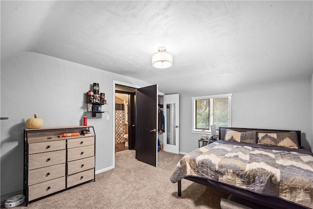 carpeted bedroom with a textured ceiling, a closet, and lofted ceiling