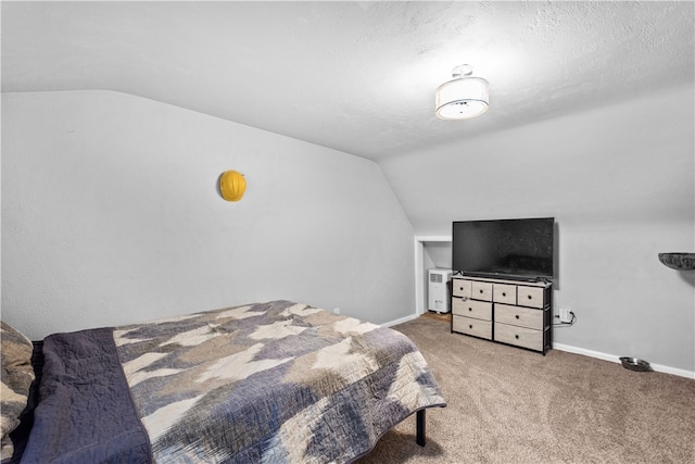 carpeted bedroom featuring a textured ceiling and vaulted ceiling