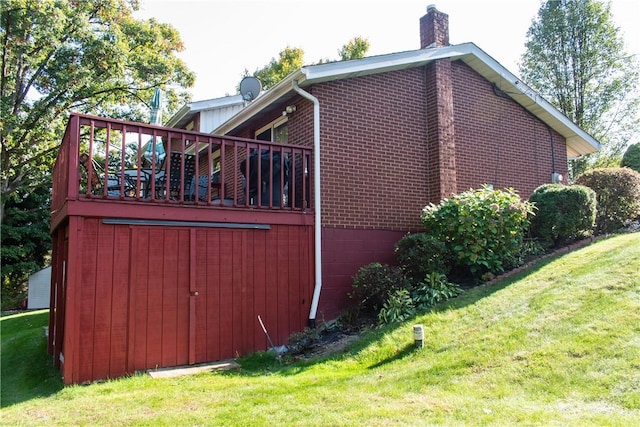 view of side of home with a yard