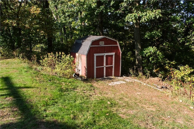 view of outbuilding featuring a lawn