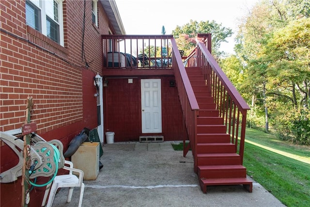 doorway to property with a yard and a patio