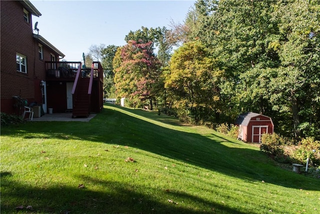 view of yard with a deck and a storage shed