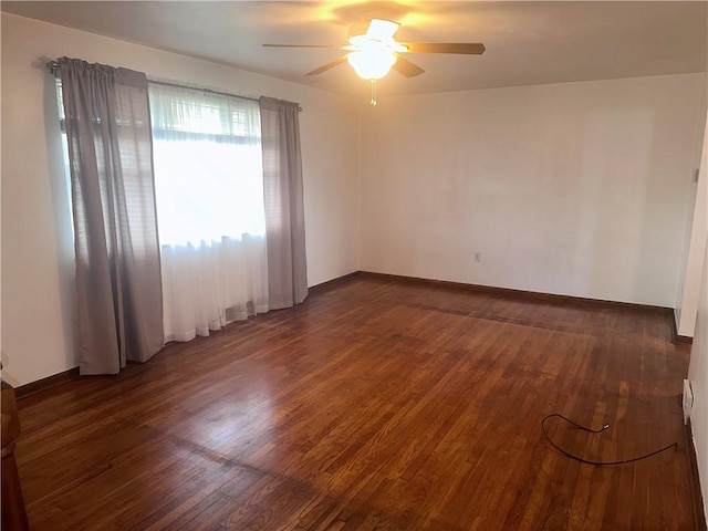 unfurnished room with dark hardwood / wood-style floors and ceiling fan