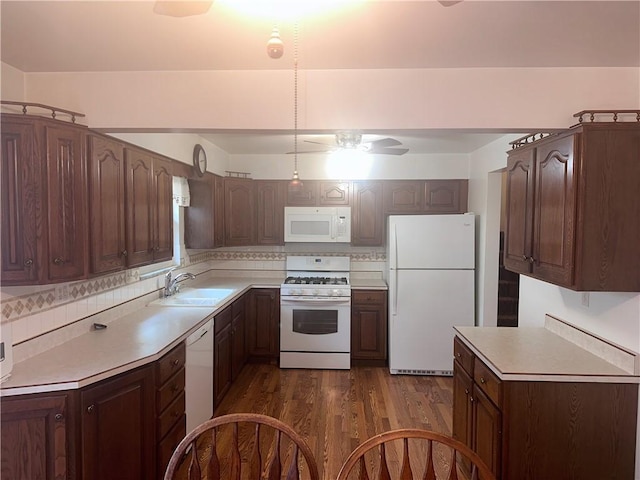 kitchen with white appliances, backsplash, sink, dark hardwood / wood-style floors, and ceiling fan